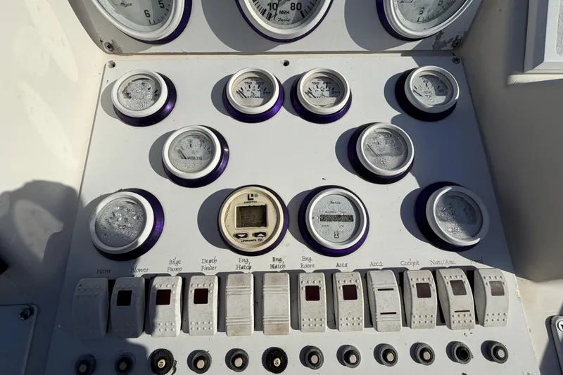 Slide: The Image of Control panel of a 1999 Black Thunder XT-430 boat with gauges and switches. - 20