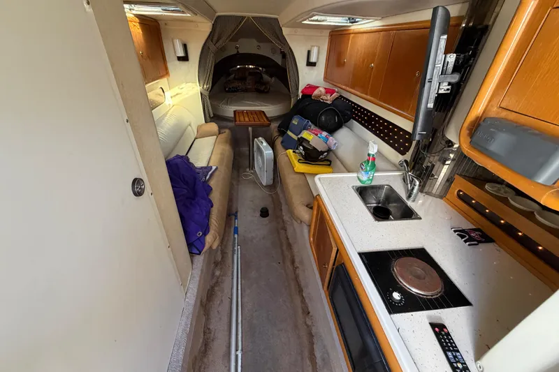 Slide: The Image of Interior of 1999 Black Thunder XT-430 boat with kitchenette and seating area. - 27