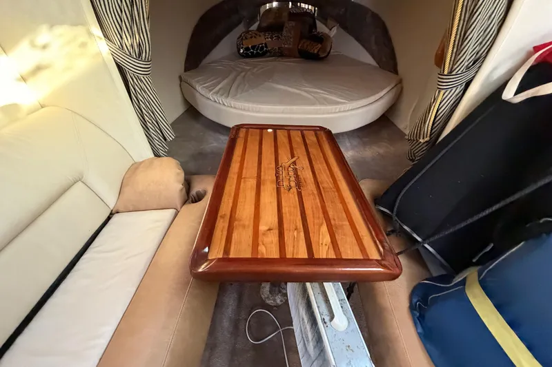 Slide: The Image of Interior of 1999 Black Thunder XT-430 boat with wooden table and cozy seating. - 29