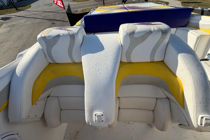 Slide: The Image of 1999 Black Thunder XT-430 boat seats with white and yellow upholstery, outdoor setting. - 36