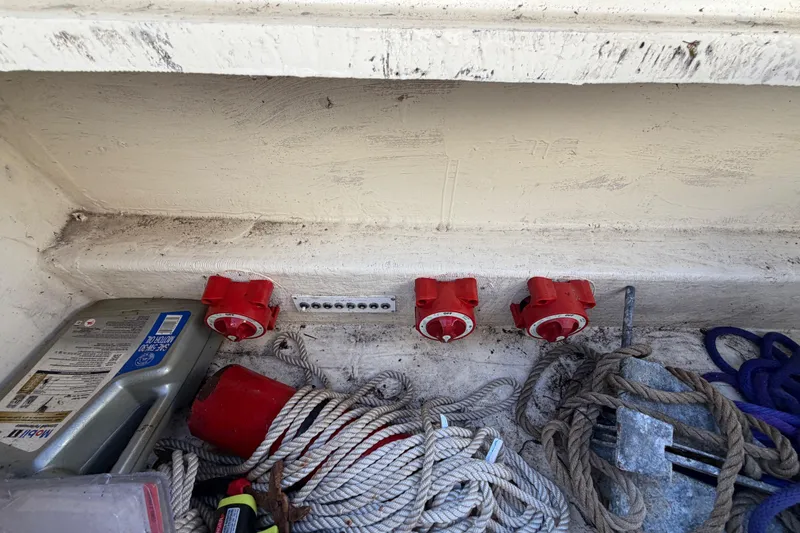 Slide: The Image of Storage compartment with ropes, red connectors, and oil container in a 1999 Black Thunder XT-430. - 38