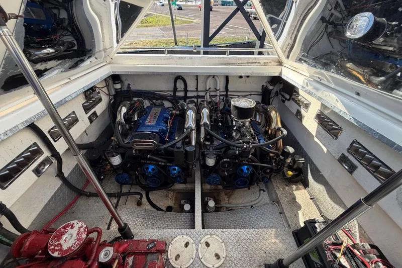 Slide: The Image of Engine compartment of a 1999 Black Thunder XT-430 boat, showcasing dual engines. - 40