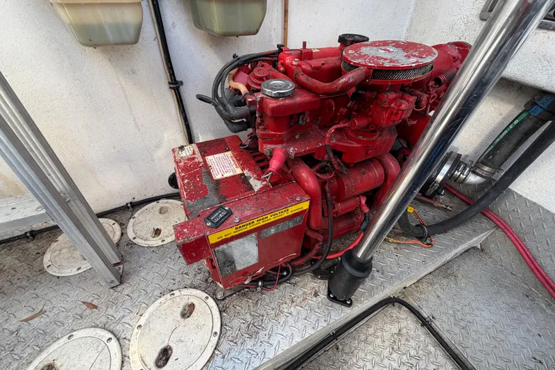 Slide: The Image of Red engine in a 1999 Black Thunder XT-430 boat, surrounded by metal flooring. - 41