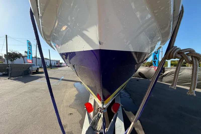 Slide: The Image of Front view of a 1999 Black Thunder XT-430 boat on display outdoors. - 8