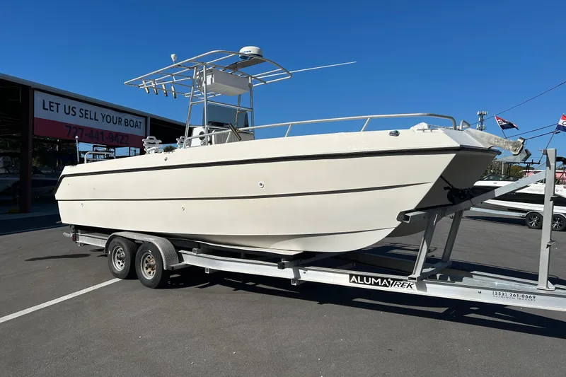 Slide: The Image of 1995 Sea Cat 255 Center Console on trailer, blue sky. - 1