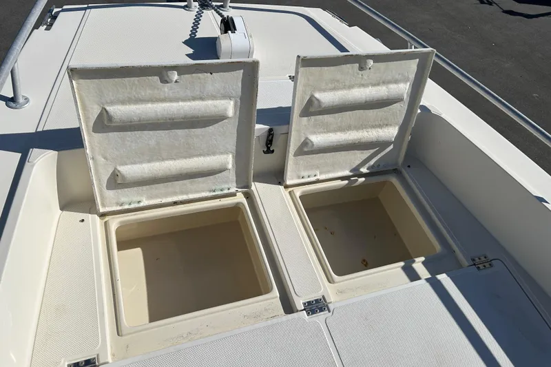 Slide: The Image of Open storage compartments on a 1995 Sea Cat 255 center console boat. - 12