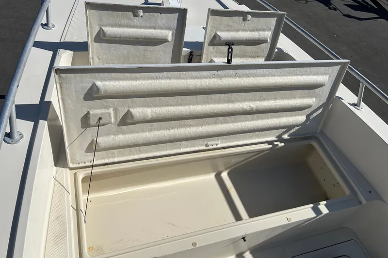 Slide: The Image of Open storage compartment on a 1995 Sea Cat 255 center console boat. - 13