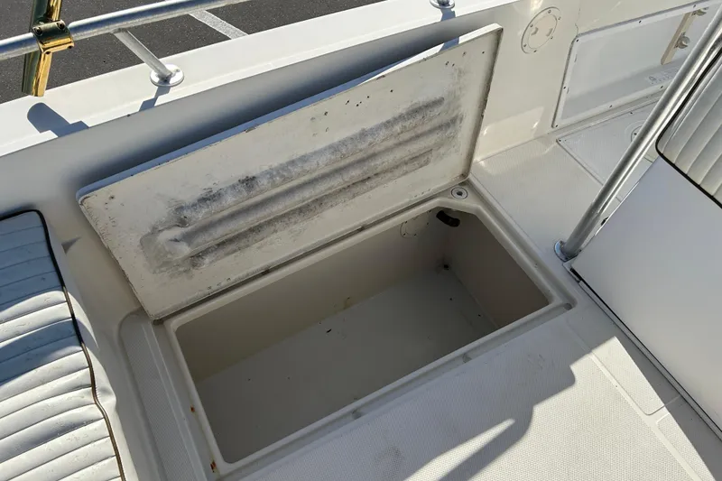 Slide: The Image of Open storage compartment on a 1995 Sea Cat 255 center console boat. - 14