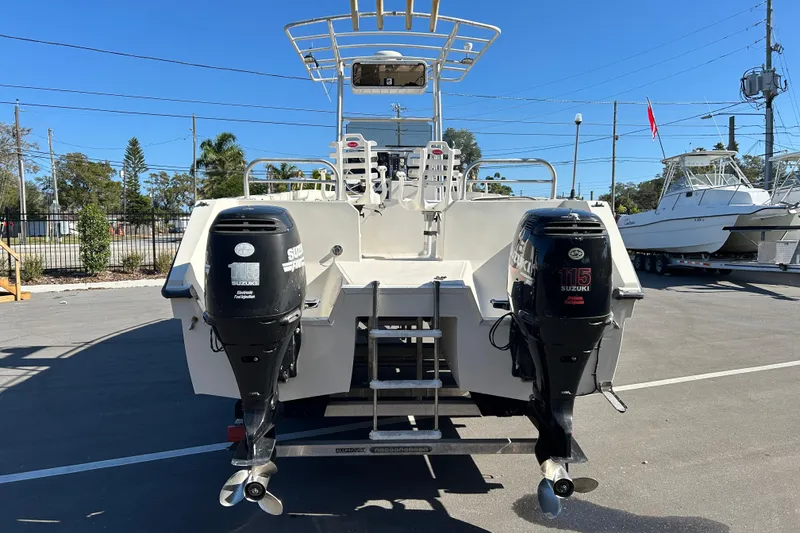 Slide: The Image of 1995 Sea Cat 255 Center Console with Suzuki engines outdoors. - 3
