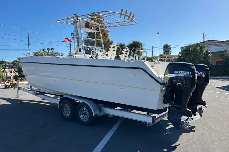 Slide: The Image of 1995 Sea Cat 255 center console on trailer with Suzuki engines. - 4