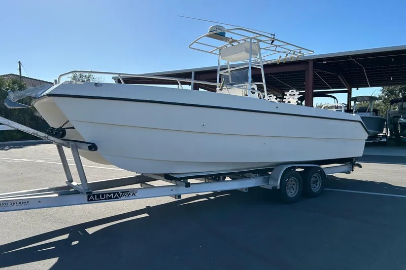 Slide: The Image of 1995 Sea Cat 255 Center Console on trailer outdoors. - 5