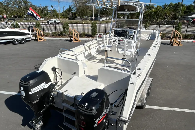 Slide: The Image of 1995 Sea Cat 255 center console with Suzuki engines on parking lot. - 7