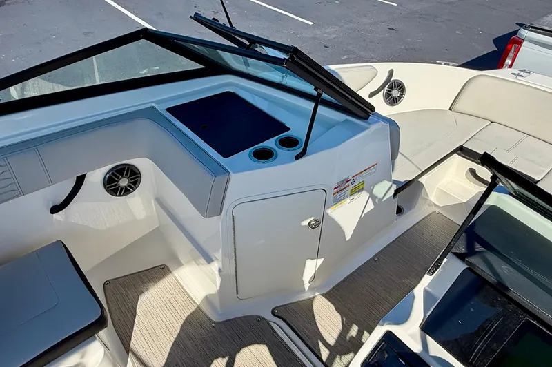 Slide: The Image of 2023 Sea Ray SPX 210 Outboard boat interior with seating and storage compartments. - 12