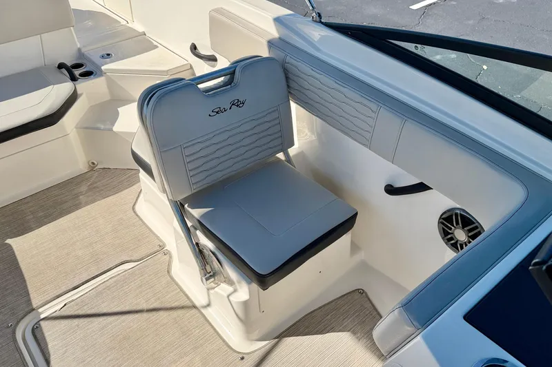 Slide: The Image of 2023 Sea Ray SPX 210 Outboard boat interior with cushioned seating and speaker. - 13