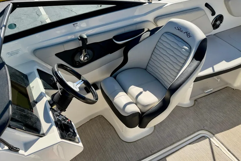 Slide: The Image of 2023 Sea Ray SPX 210 Outboard boat interior with steering wheel and captain's seat. - 14