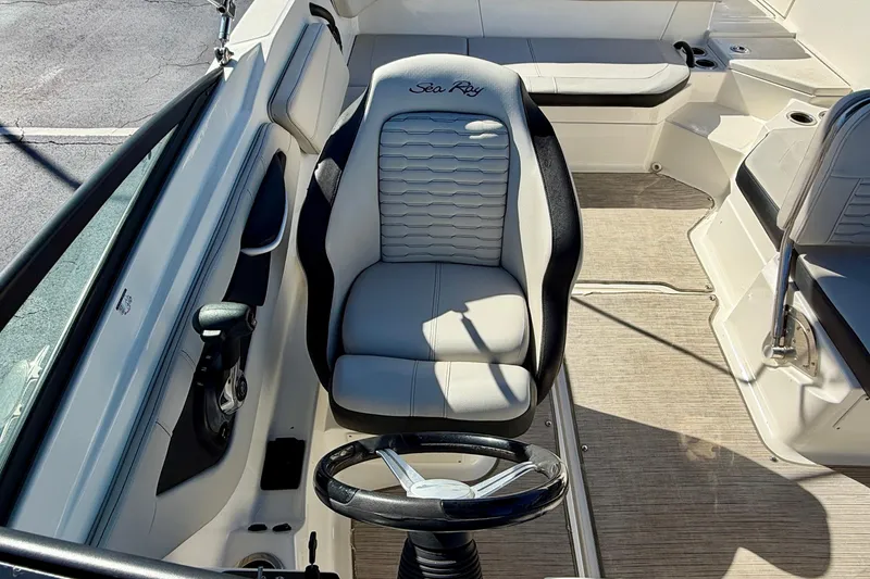 Slide: The Image of 2023 Sea Ray SPX 210 Outboard boat interior with steering wheel and seating. - 15