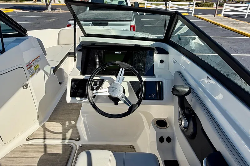 Slide: The Image of 2023 Sea Ray SPX 210 Outboard boat cockpit with steering wheel and control panel. - 16
