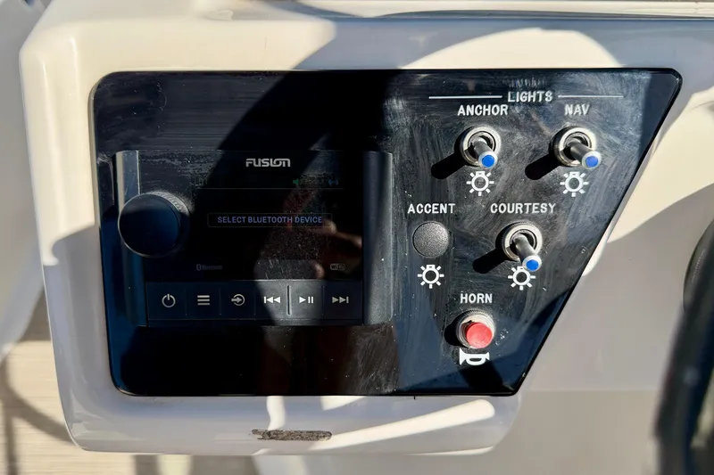 Slide: The Image of Control panel of 2023 Sea Ray SPX 210 Outboard with audio and light switches. - 18