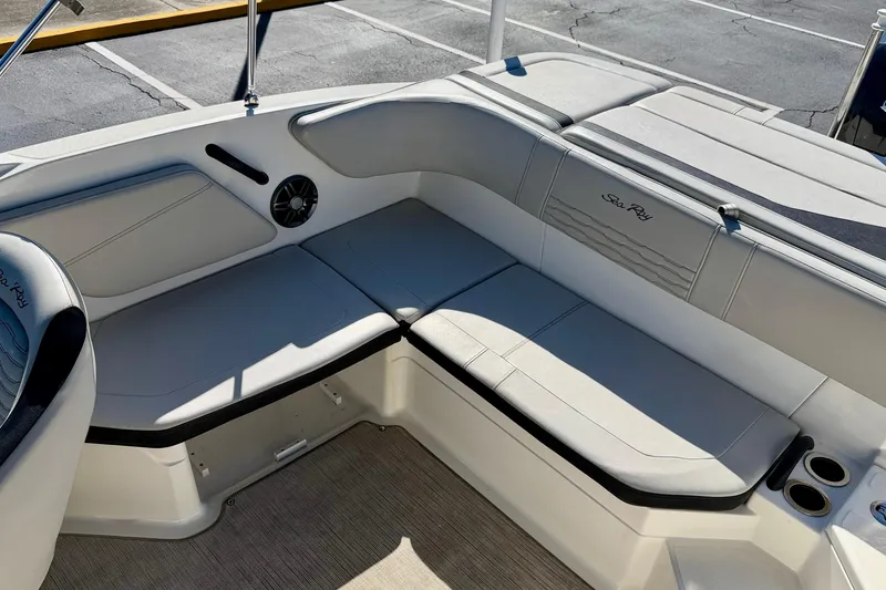 Slide: The Image of 2023 Sea Ray SPX 210 Outboard boat interior with cushioned seating and cup holders. - 20