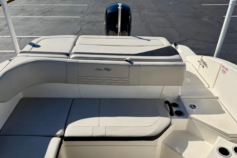 Slide: The Image of 2023 Sea Ray SPX 210 Outboard boat interior with cushioned seating and cup holders. - 21