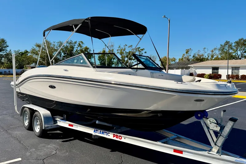 Slide: The Image of 2023 Sea Ray SPX 210 Outboard boat on trailer, parked outdoors. - 4
