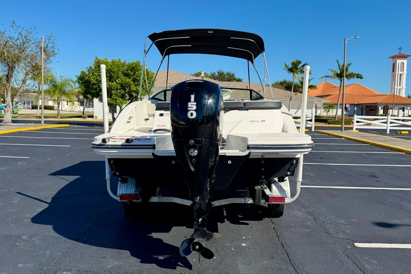 Slide: The Image of 2023 Sea Ray SPX 210 Outboard boat with 150 HP engine in a parking lot. - 6