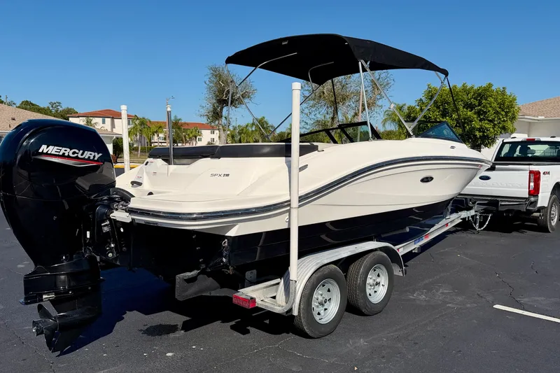 Slide: The Image of 2023 Sea Ray SPX 210 Outboard boat on trailer, featuring Mercury engine. - 7