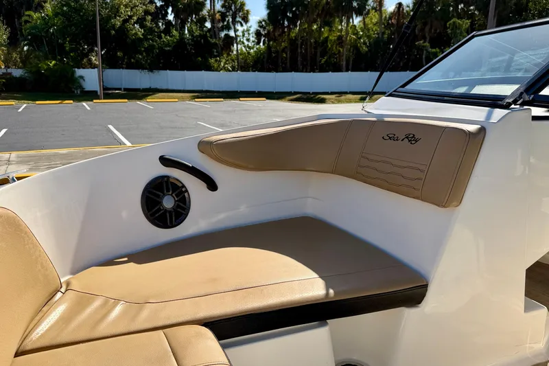 Slide: The Image of 2022 Sea Ray SPX 210 Outboard boat interior with tan seating and speaker. - 10