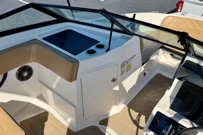 Slide: The Image of 2022 Sea Ray SPX 210 Outboard boat interior with beige seating and cup holders. - 13