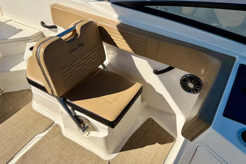 Slide: The Image of 2022 Sea Ray SPX 210 Outboard boat interior with tan seating and speaker. - 14