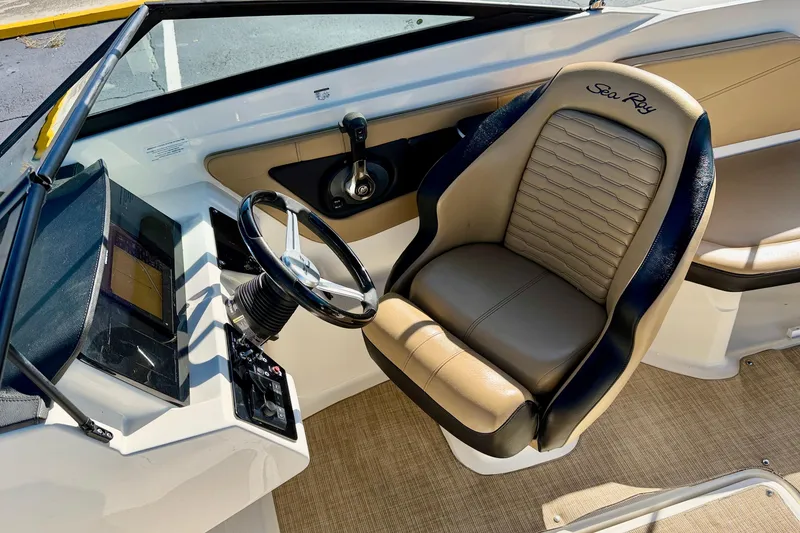 Slide: The Image of 2022 Sea Ray SPX 210 Outboard cockpit with steering wheel and comfortable seating. - 15