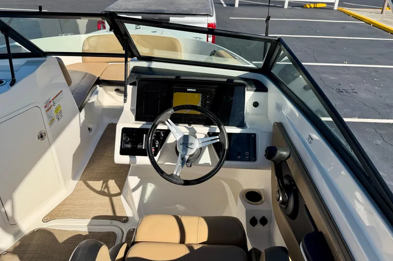 Slide: The Image of 2022 Sea Ray SPX 210 Outboard boat interior with steering wheel and dashboard controls. - 16