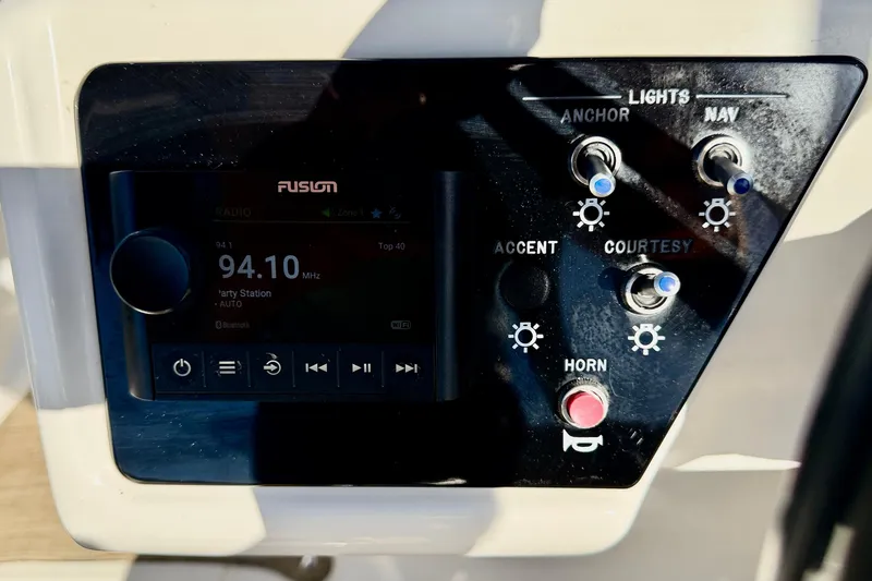 Slide: The Image of Control panel of 2022 Sea Ray SPX 210 Outboard with radio and light switches. - 19