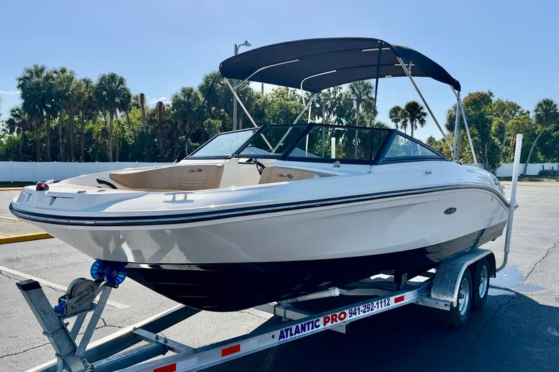 Slide: The Image of 2022 Sea Ray SPX 210 Outboard boat on trailer, parked outdoors. - 2