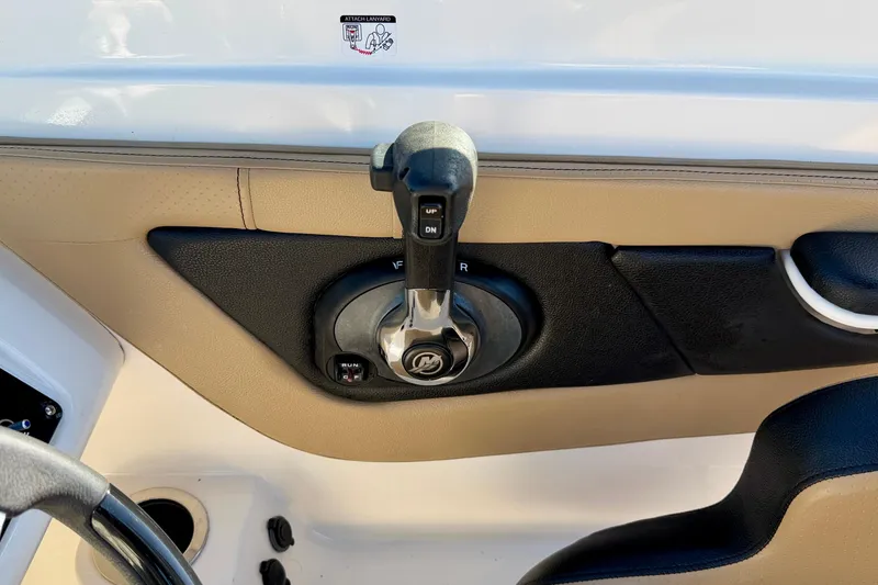 Slide: The Image of Throttle control of 2022 Sea Ray SPX 210 Outboard boat, featuring beige and black interior. - 20