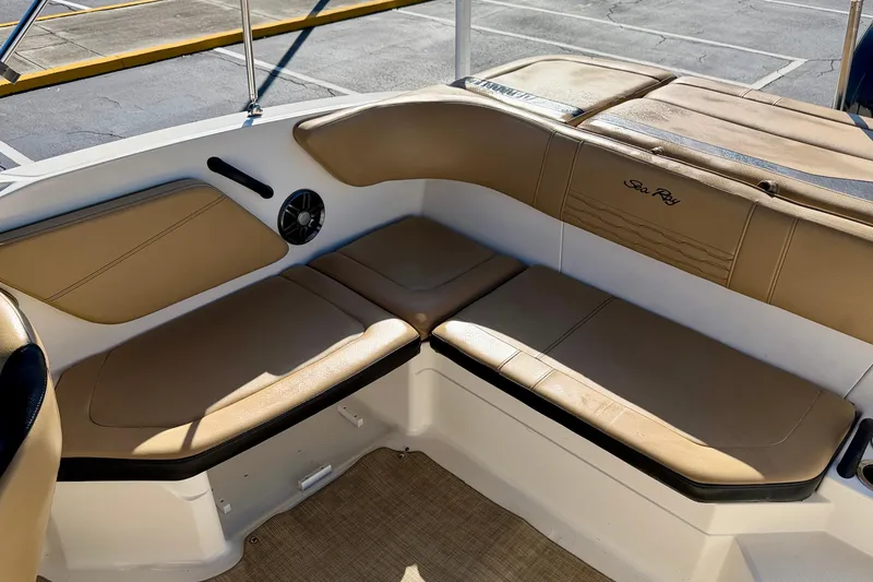 Slide: The Image of 2022 Sea Ray SPX 210 Outboard boat interior with tan seating and speaker. - 22