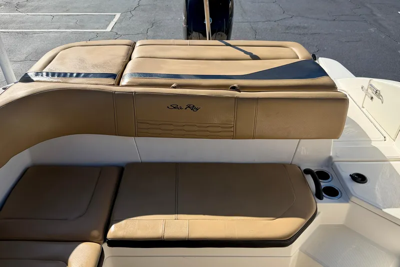 Slide: The Image of 2022 Sea Ray SPX 210 Outboard boat interior with tan seating and cup holders. - 23