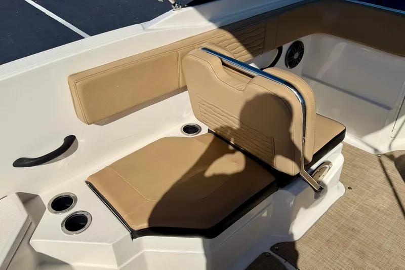 Slide: The Image of 2022 Sea Ray SPX 210 Outboard boat interior with tan seating and cup holders. - 24