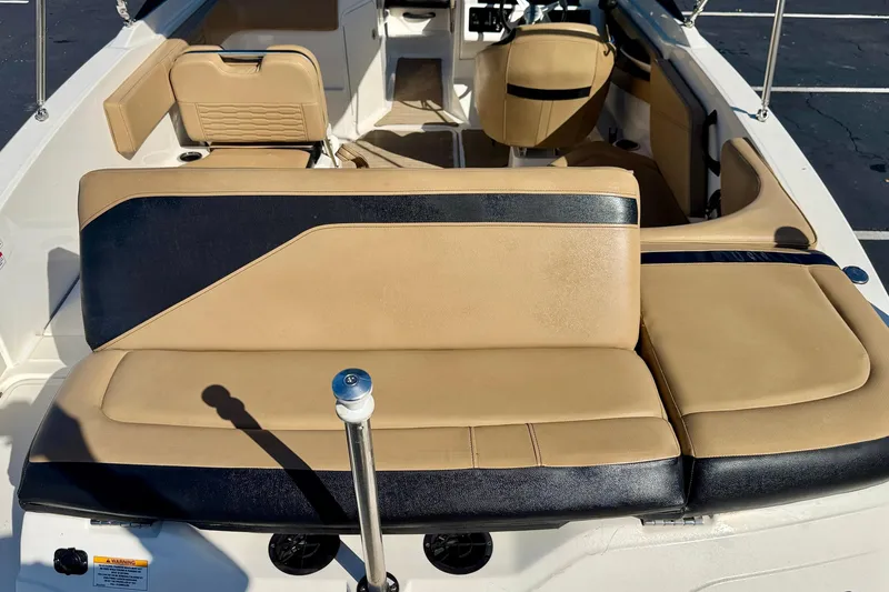 Slide: The Image of 2022 Sea Ray SPX 210 Outboard boat interior with tan and black seating. - 25
