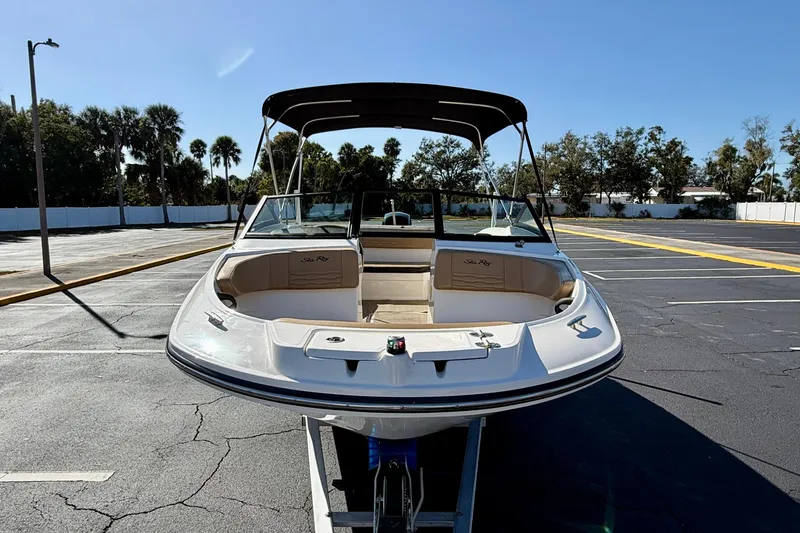 Slide: The Image of 2022 Sea Ray SPX 210 Outboard boat with canopy in a sunny parking lot. - 3