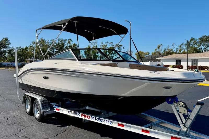 Slide: The Image of 2022 Sea Ray SPX 210 Outboard boat on trailer, featuring sleek design and canopy. - 4