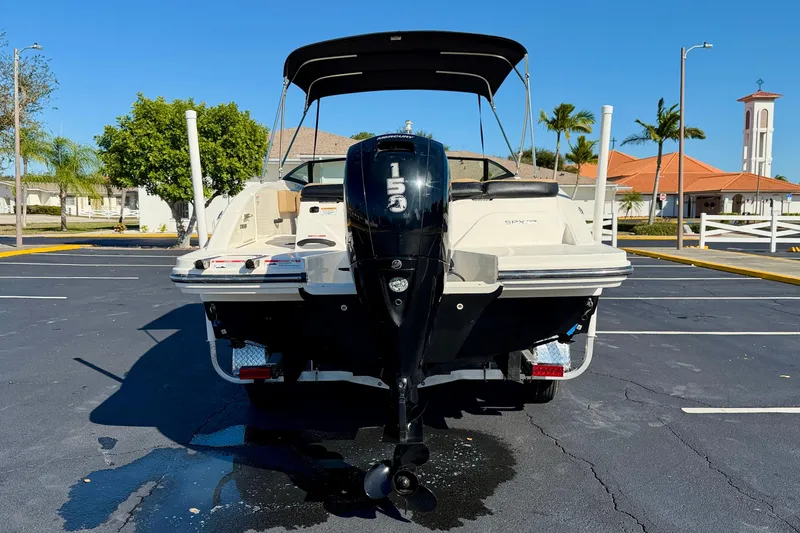 Slide: The Image of 2022 Sea Ray SPX 210 Outboard boat parked, showcasing rear view and outboard motor. - 6