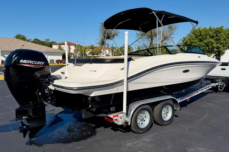Slide: The Image of 2022 Sea Ray SPX 210 Outboard boat on trailer, featuring a Mercury engine. - 7