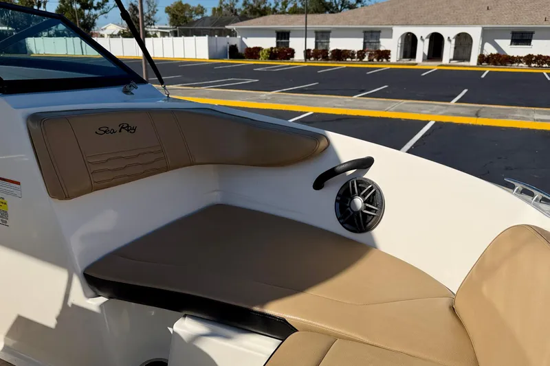 Slide: The Image of 2022 Sea Ray SPX 210 Outboard boat interior with tan seating and speaker. - 9