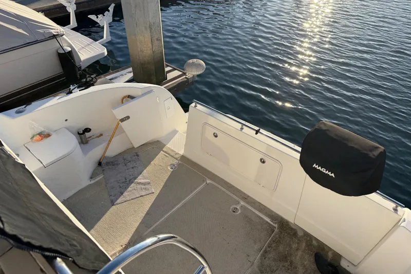 Slide: The Image of 2007 Meridian 459 Motoryacht deck with dock view and Magma grill cover. - 12