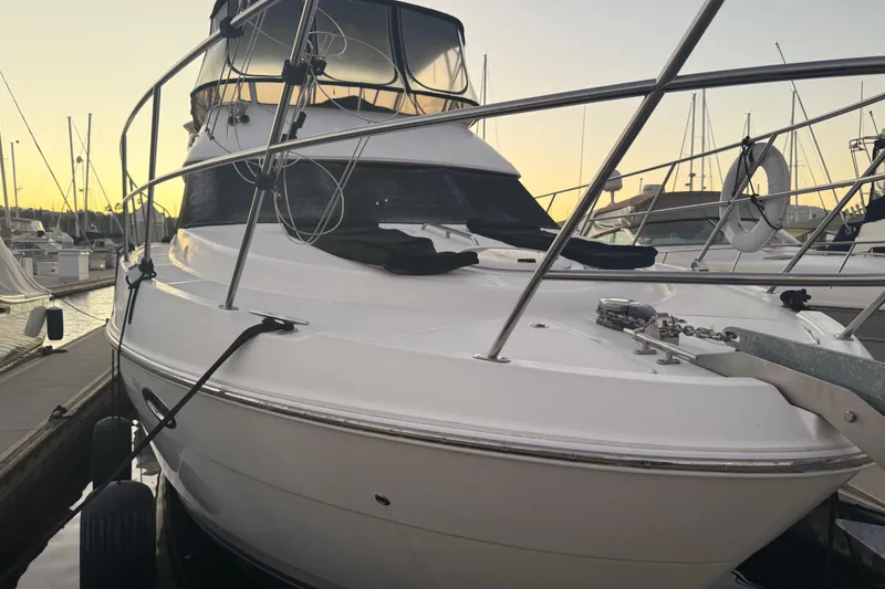 Slide: The Image of 2007 Meridian 459 Motoryacht docked at sunset, showcasing sleek design and spacious deck. - 3