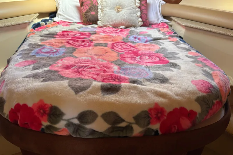 Slide: The Image of Floral bedspread in 2007 Meridian 459 Motoryacht cabin, featuring vibrant pink and red flowers. - 34