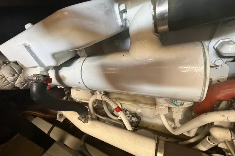 Slide: The Image of Engine compartment of a 2007 Meridian 459 Motoryacht, showcasing mechanical components and hoses. - 39