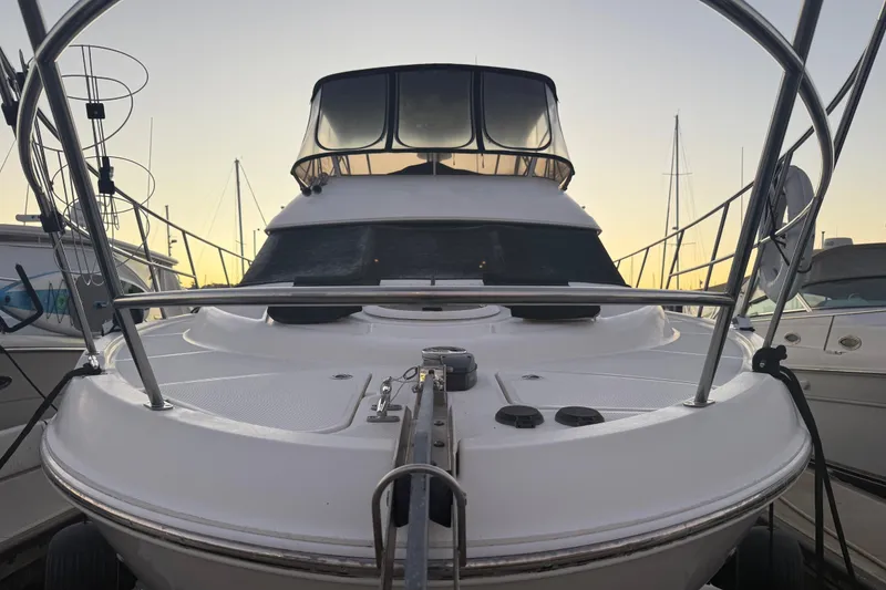 Slide: The Image of 2007 Meridian 459 Motoryacht docked at sunset, showcasing sleek design and spacious deck. - 4