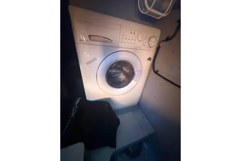 Slide: The Image of Washing machine inside 2007 Meridian 459 Motoryacht laundry area. - 48